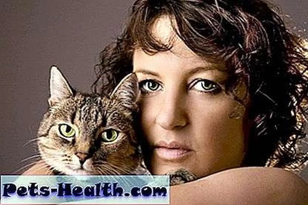 Woman hugging her cat by Shutterstock Woman hugging her cat by Shutterstock